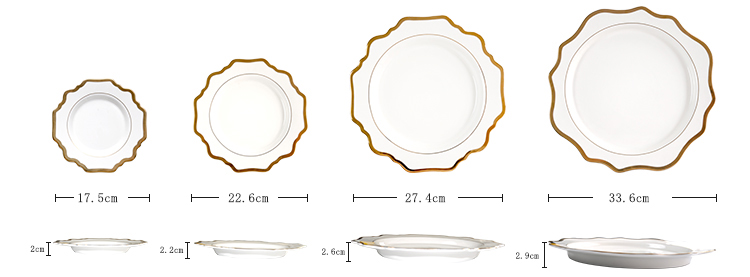 white porcelain dinner plates set with gold trim